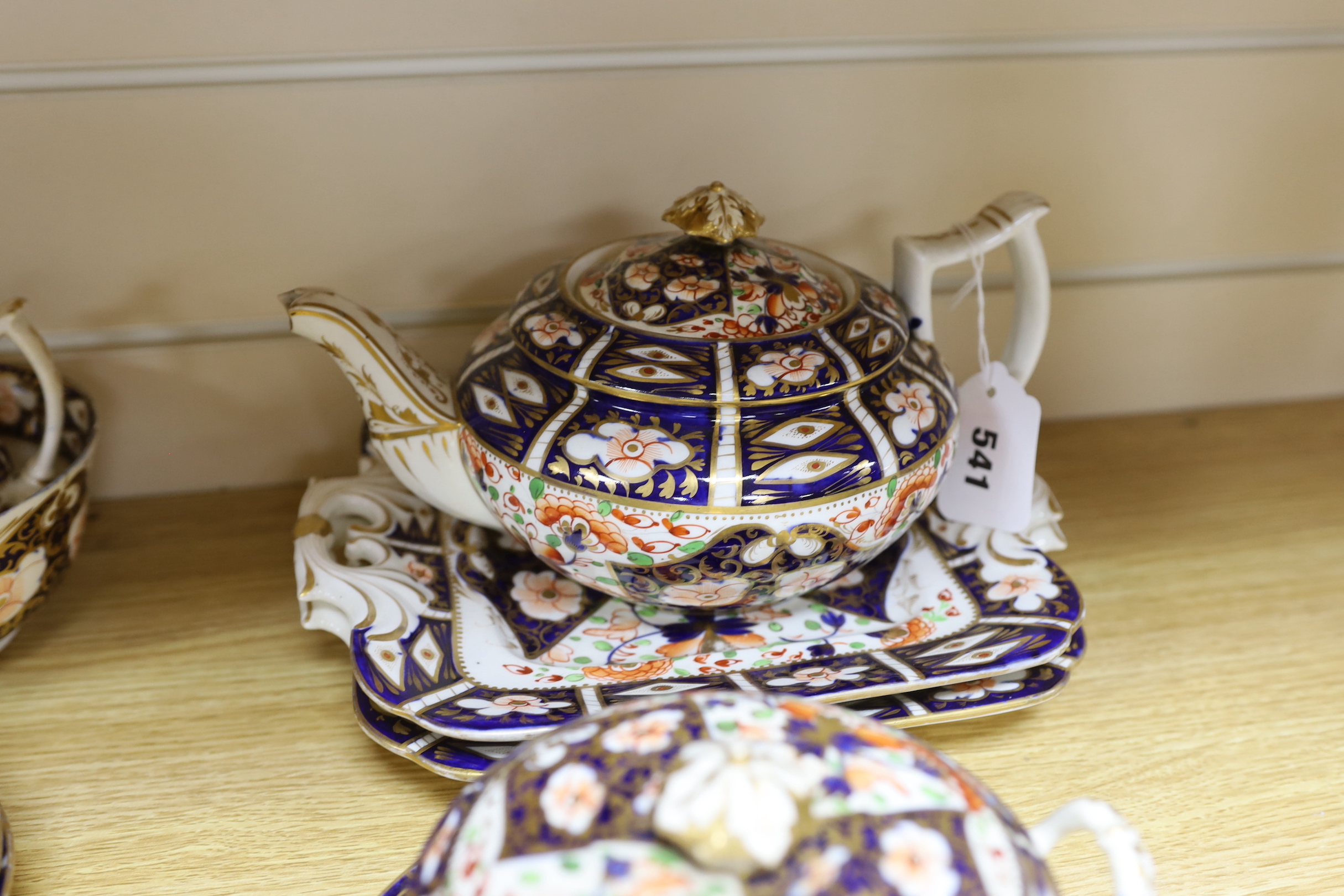 A mid 19th century Derby Imari pattern tea service, comprising a pair of two handled cake plates, a teapot on stand, a sucrier, a cream jug, a bowl and cover, three cups and four saucers, NB: From the Estate of Rt Hon Lo